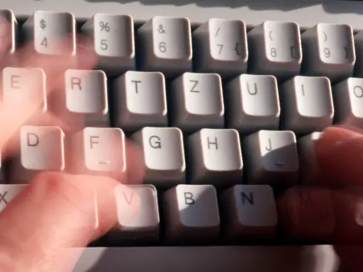 Hände tippen schnell auf einer Tastatur. Vielleicht wird gerade ein Befehl wie "diskpart delete partition" eingegeben.